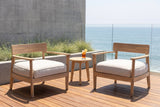 Two Furnari acacia club chairs on an ipe deck above the ocean in La Jolla, a board-formed concrete wall and glass balustrade behind (side table not included)