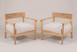 The Furnari set of two acacia club chairs with beige seat cushions, three-quarter view on a light studio backdrop