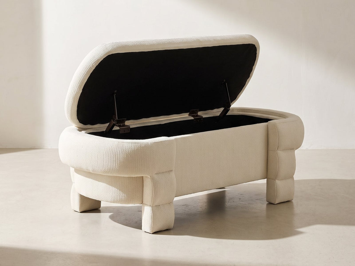 Gaeta Oval Storage Bench in ivory against a plaster wall in morning light