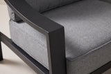 Close-up of the Galati chair: the black aluminum arm turning its square corner onto the front leg, beside the dark gray seat cushion