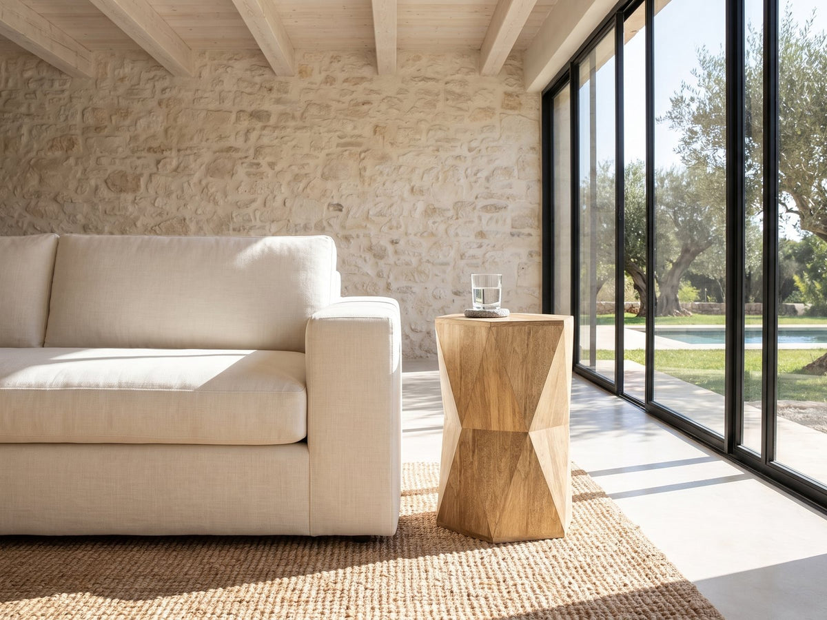 Gallicano Mango Faceted Hexagon Side Table beside a linen sofa in a poolside villa