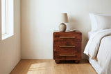 Galtelli chestnut mango nightstand against a warm ivory plaster wall in a Napa Valley bedroom with honey oak floors