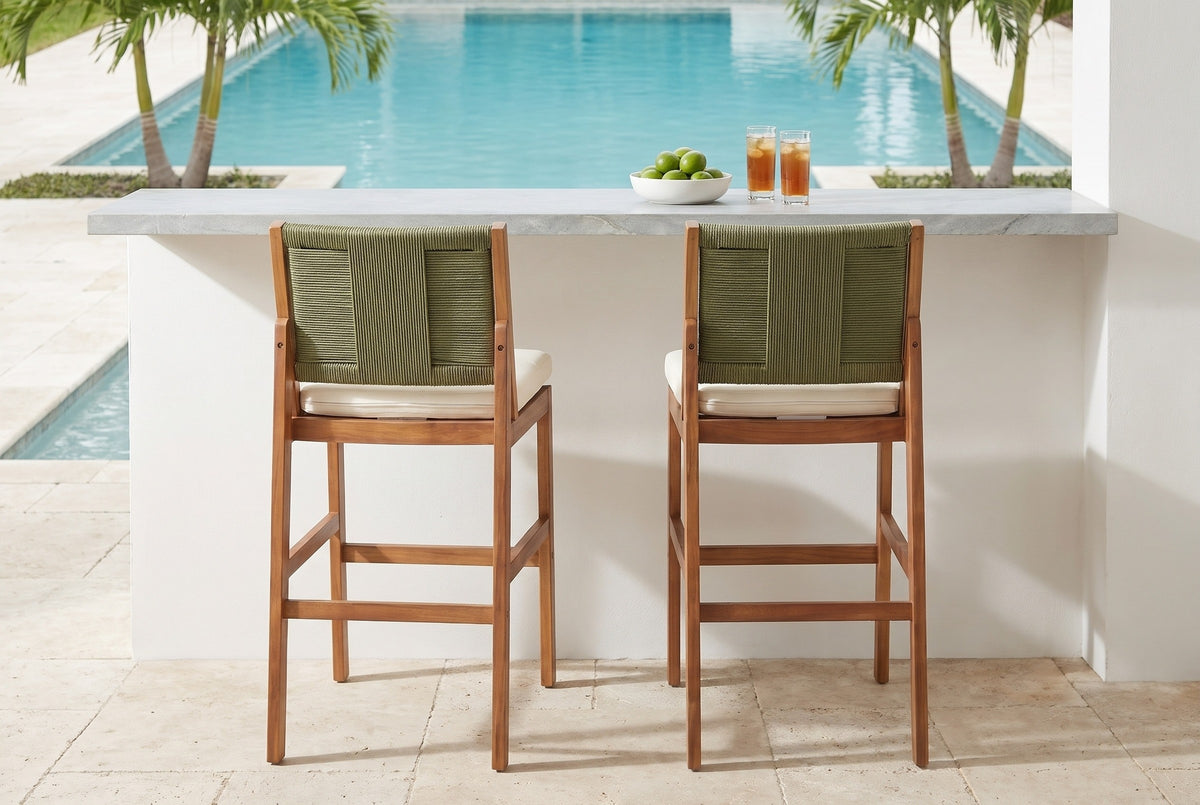 Two Ganzirri acacia bar stools at a quartzite-topped white stucco bar by a Boca Raton pool, palms and turquoise water behind (bar counter not included)
