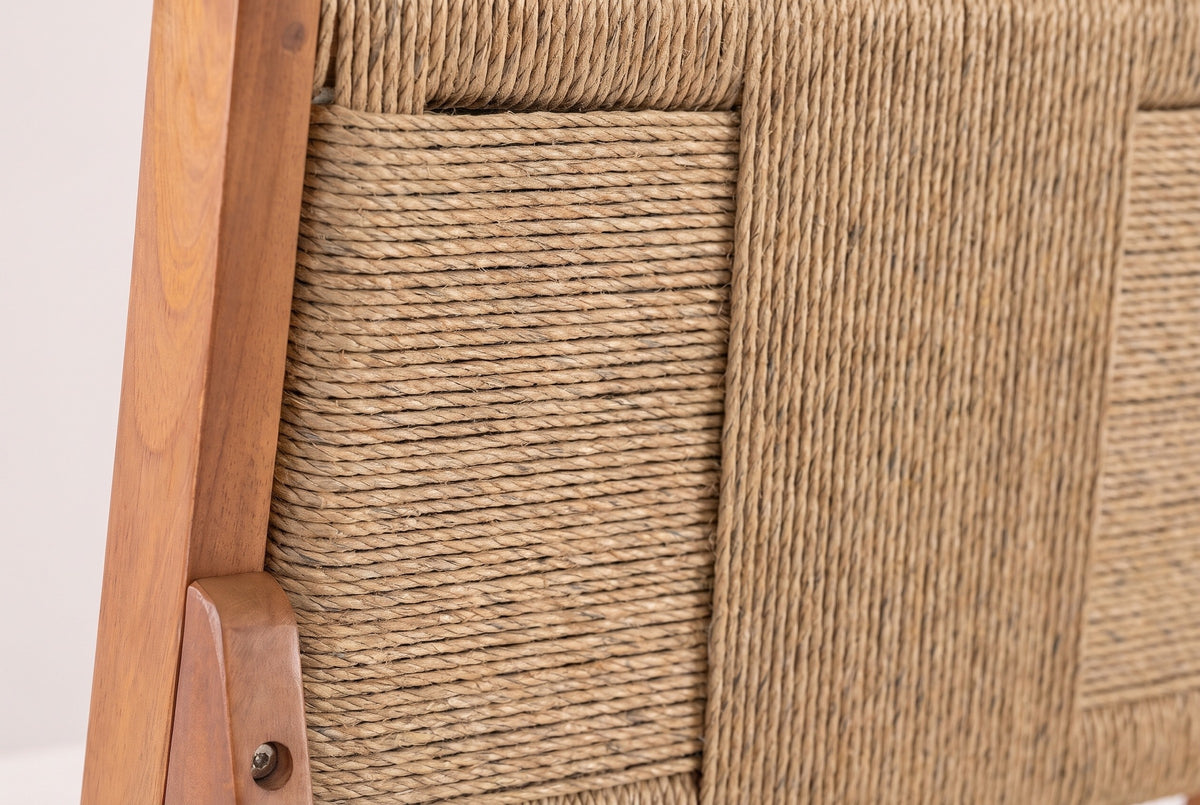 Close-up of the light brown wicker back of a Ganzirri stool and its acacia post with a round bolt head