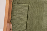 Close-up of the sage-green wicker back of a Ganzirri stool and its acacia post with a round bolt head