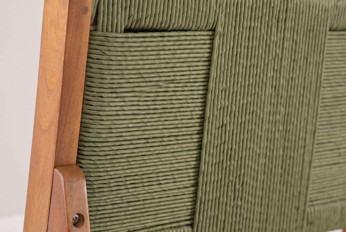 Close-up of the sage-green wicker back of a Ganzirri stool and its acacia post with a round bolt head