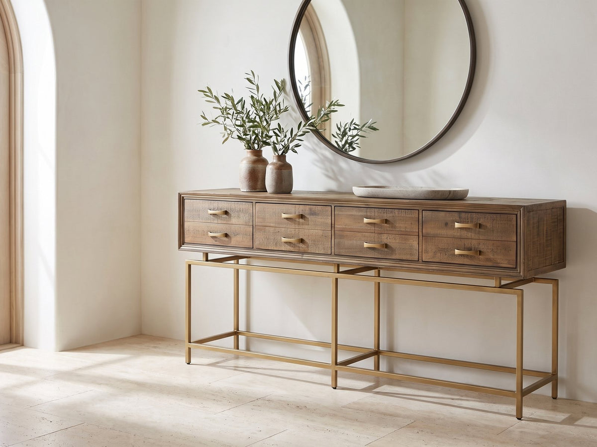 Gasperina Reclaimed Fir Four-Drawer Console Table under a round mirror in a travertine entryway