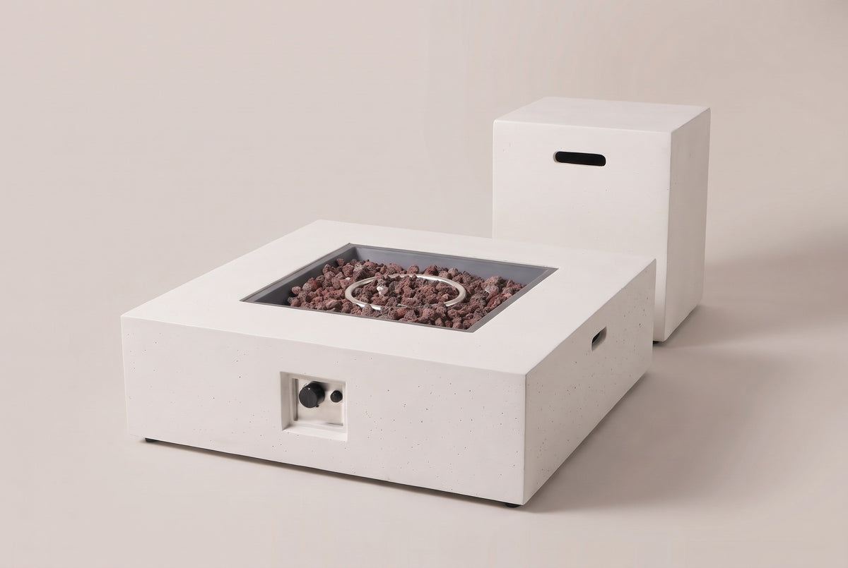 The Gela square fire pit and its tank holder in white concrete, three-quarter view on a light studio backdrop, the control niche on the front face