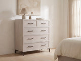 Gemona 41-Inch Cerused Oak 5-Drawer Chest against a plaster wall under an abstract canvas in a bright bedroom