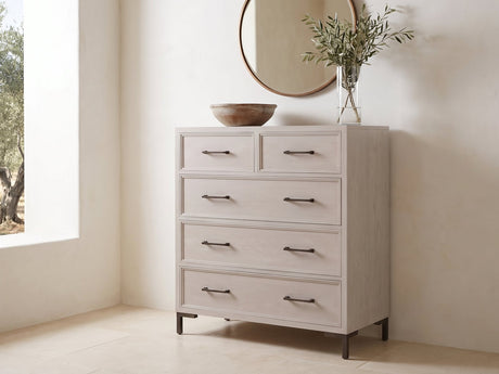 Gemona 41-Inch Cerused Oak 5-Drawer Chest under a round bronze mirror in a villa bedroom