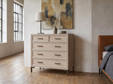 Gemona 41-Inch Cerused Oak 5-Drawer Chest against a plaster wall in an industrial loft bedroom