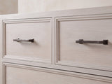 Close-up of the Gemona 41-Inch Cerused Oak 5-Drawer Chest: the dark bronze bar pulls on the two small top drawers