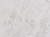 Close-up of the Genazzano White Marble Tapered Pedestal Side Table: the soft white marble of the top