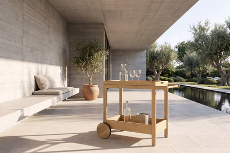 Gerocarne 36-Inch Acacia Wood Outdoor Rolling Bar Cart in a garden terrace