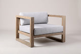 The Giardini eucalyptus lounge chair with light gray cushions, three-quarter front view on a light studio backdrop