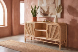 Giovinazzo rattan and cane sideboard against a terracotta-pink limewash wall in an Austin entryway with a concrete floor and a jute runner