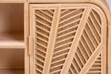 A door of the Giovinazzo sideboard up close: thick double rattan spines with thin rods branching off like palm veins, open cane between the rods, and the short round rattan pull on the inner edge