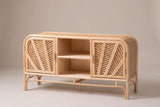 The Giovinazzo rattan and cane sideboard, three-quarter view on a light studio backdrop: two palm-leaf doors, an open centre bay and an open pole base