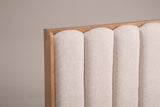 The upper left of the Giulianova headboard: four padded oatmeal channels with rounded arches inside the slim pine frame