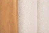 Close-up of the Giulianova bed where the wheat pine frame meets the oatmeal woven fabric of two padded channels