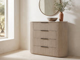 Gradisca 50-Inch Light Oak 4-Drawer Chest under a round bronze mirror in a villa bedroom