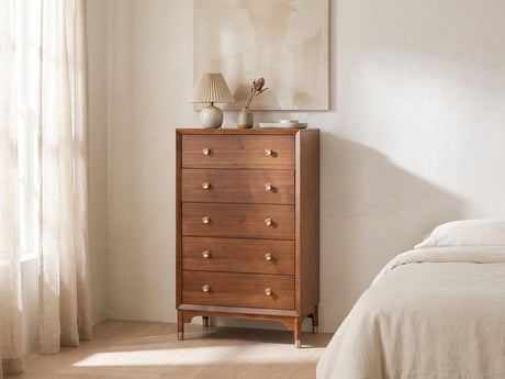 Grado 34-Inch Warm Walnut 5-Drawer Chest against a plaster wall under an abstract canvas in a bright bedroom