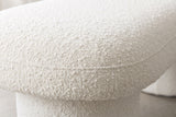 Close-up of the ivory boucle on the Gubbio bench: loops and small nubs in a soft warm white, with a fine seam along the rounded edge of the top