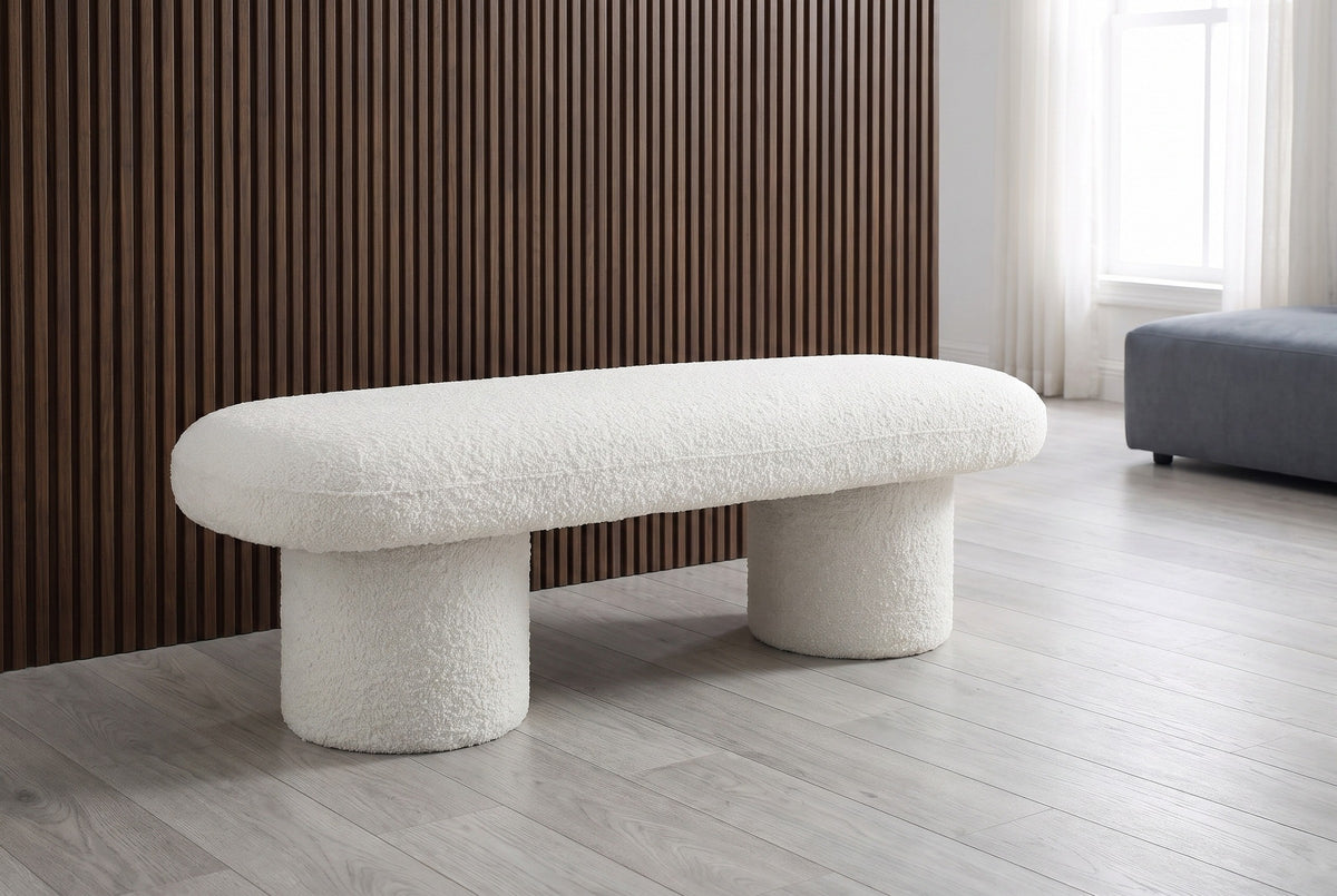 Gubbio ivory boucle bench in front of a dark walnut slat wall in a New York loft with a pale grey-washed oak floor