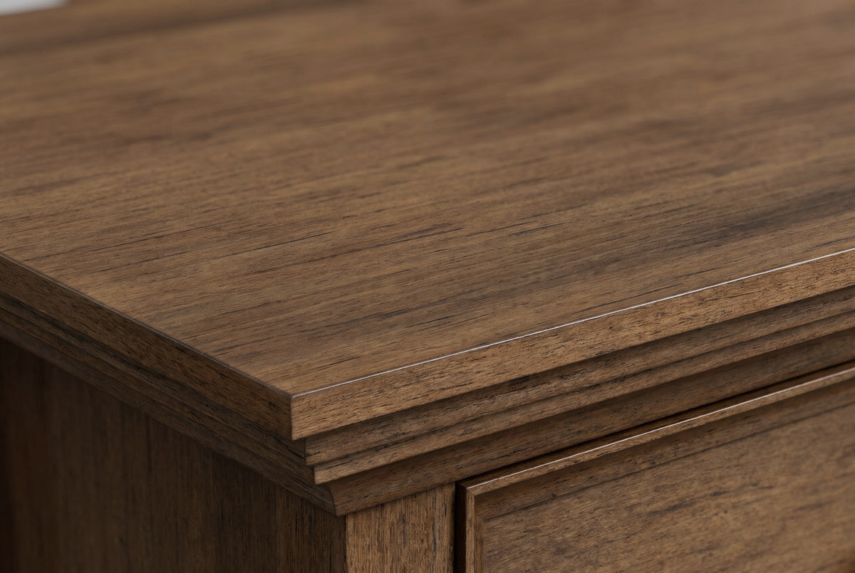 Close-up of the rustic aged brown wood on the Iglesias nightstand: fine grain with darker streaks running to the crown moulding