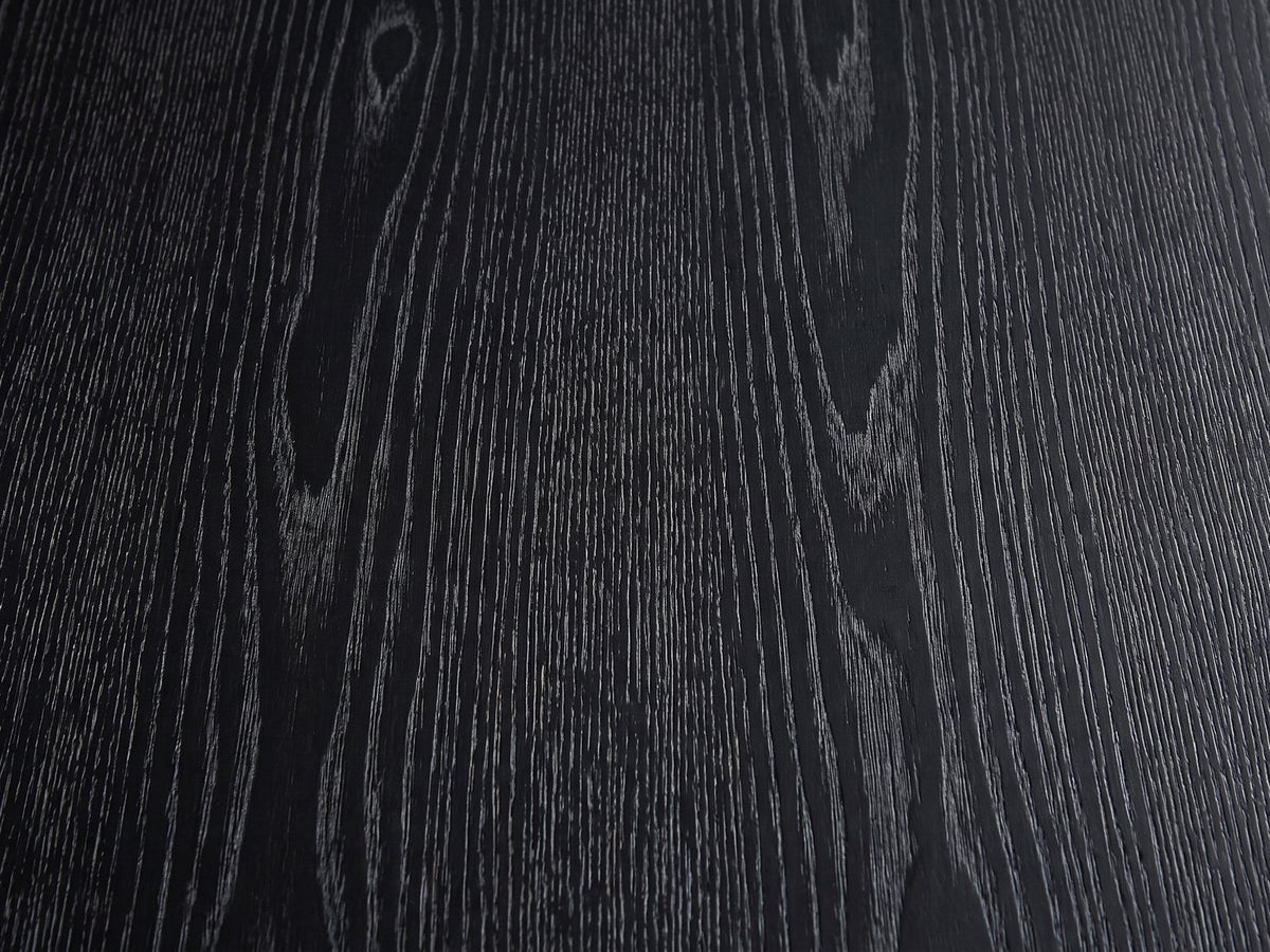 Close-up of the Imola Black Ash Oval Pedestal Coffee Table: the open-pore black ash grain of the top
