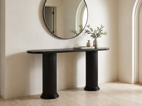 Imola Black Wood Veneer Oval Column Console Table under a round mirror in a travertine entryway