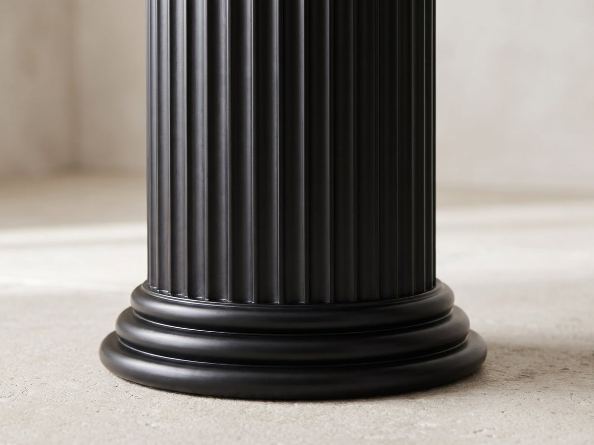 Close-up of the Imola Black Wood Veneer Oval Column Console Table: the foot of a fluted column on its stepped round plinth