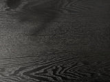 Close-up of the Imola Black Wood Veneer Oval Column Console Table: the open grain of the black veneer top