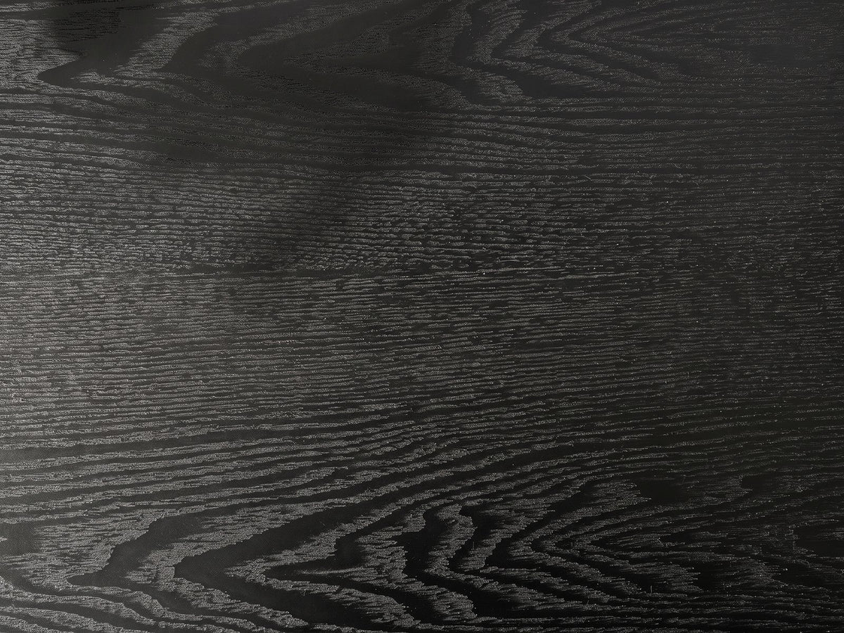 Close-up of the Imola Black Wood Veneer Oval Column Console Table: the open grain of the black veneer top
