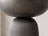 Close-up of the Irsina Cast Aluminum Tulip Pedestal Side Table: the cast bowl resting on the ribbed pedestal