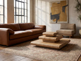 Ischia Natural Wood Veneer Stacking Coffee Table on a vintage rug in front of a leather sofa in an industrial loft