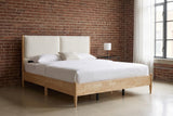 Isernia bed against a red-brown brick wall in a Brooklyn loft bedroom with a polished concrete floor and a steel window