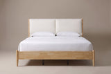 Isernia bed in natural rubberwood with two cream cushions, a white mattress and pillows (not included), front view