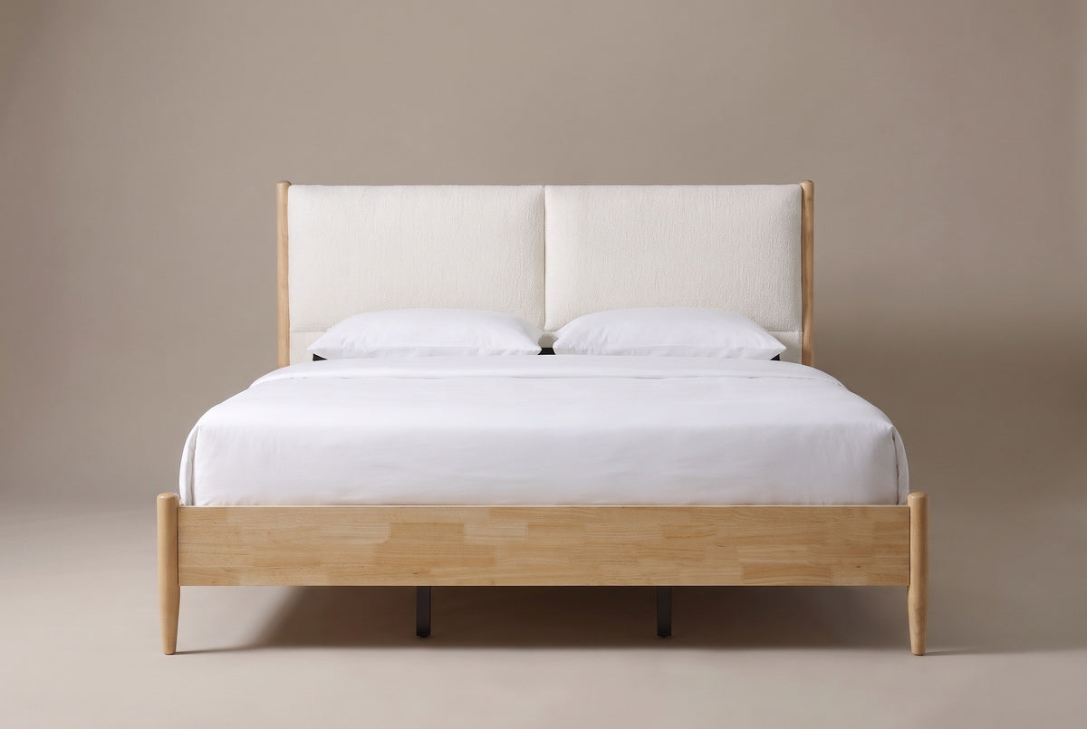 Isernia bed in natural rubberwood with two cream cushions, a white mattress and pillows (not included), front view