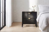 Isili black fluted nightstand beside a bed in a Chicago loft bedroom with a whitewashed brick wall and a tall black steel window