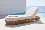 Isnello woven lounger on pale limestone beside an infinity pool at a La Jolla house, a white concrete wall and the Pacific behind (towel not included)