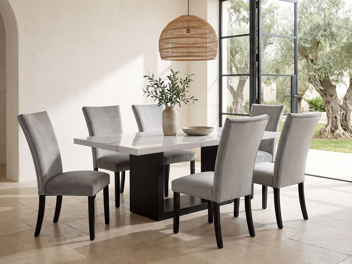 Itri 70-Inch White Marble Double Pedestal Dining Set with 6 Chairs in a sunlit villa dining area with olive trees outside
