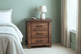 Ittiri reclaimed pine nightstand with a ceramic lamp against a sage green plaster wall in a Charleston bedroom with linen curtains and a pale oak floor
