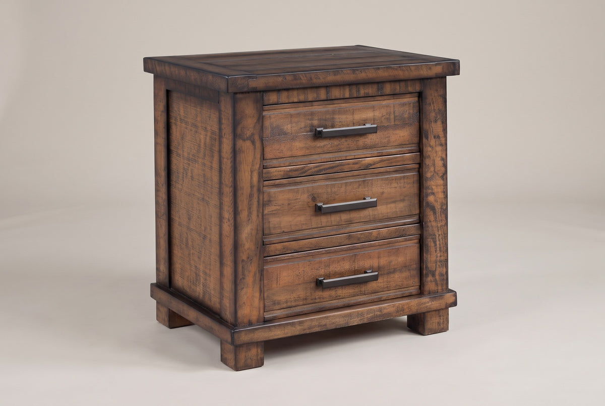 The Ittiri nightstand, three-quarter view on a light studio backdrop: a framed plank top, three drawers with bronze bar pulls, wide corner posts, a base rail and block feet