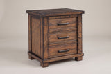 The Ittiri nightstand, three-quarter view on a light studio backdrop: a framed plank top, three drawers with bronze bar pulls, wide corner posts, a base rail and block feet