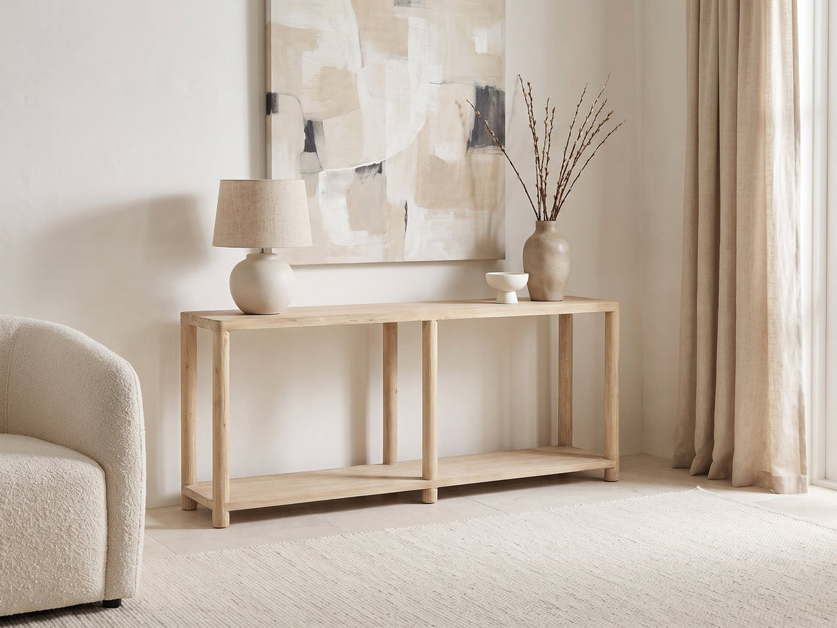 Ivrea Reclaimed Pine Console Table against a plaster wall under an abstract canvas in a bright living room