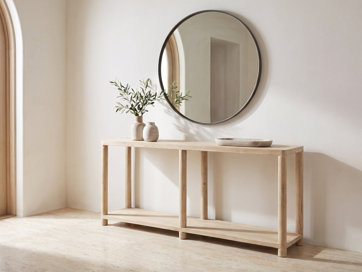 Ivrea Reclaimed Pine Console Table under a round mirror in a travertine entryway
