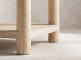 Close-up of the Ivrea Reclaimed Pine Console Table: a round pine leg passing the lower shelf and ending in a short round foot