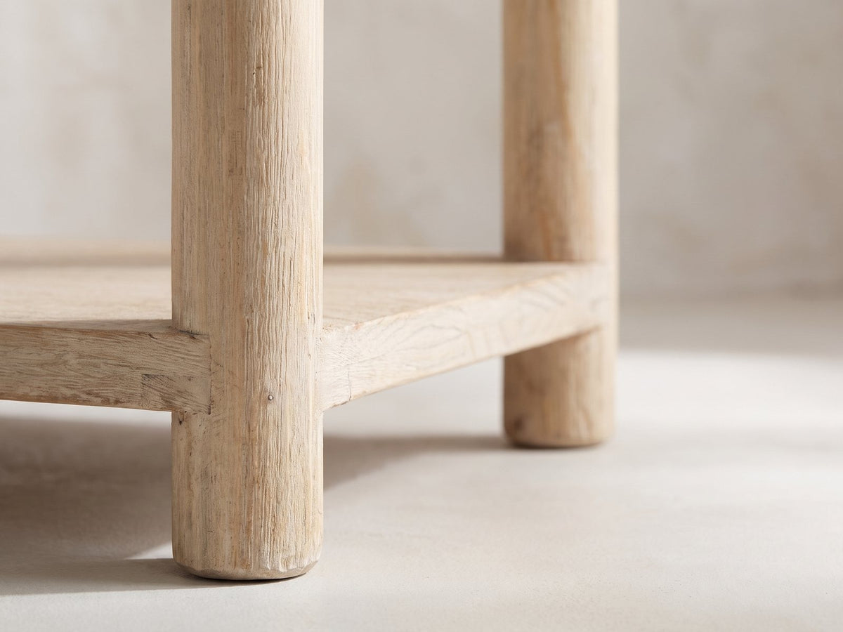 Close-up of the Ivrea Reclaimed Pine Console Table: a round pine leg passing the lower shelf and ending in a short round foot