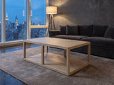 Ivrea Reclaimed Pine Open-Frame Coffee Table on a wool rug in front of a velvet sofa in a city penthouse at blue hour